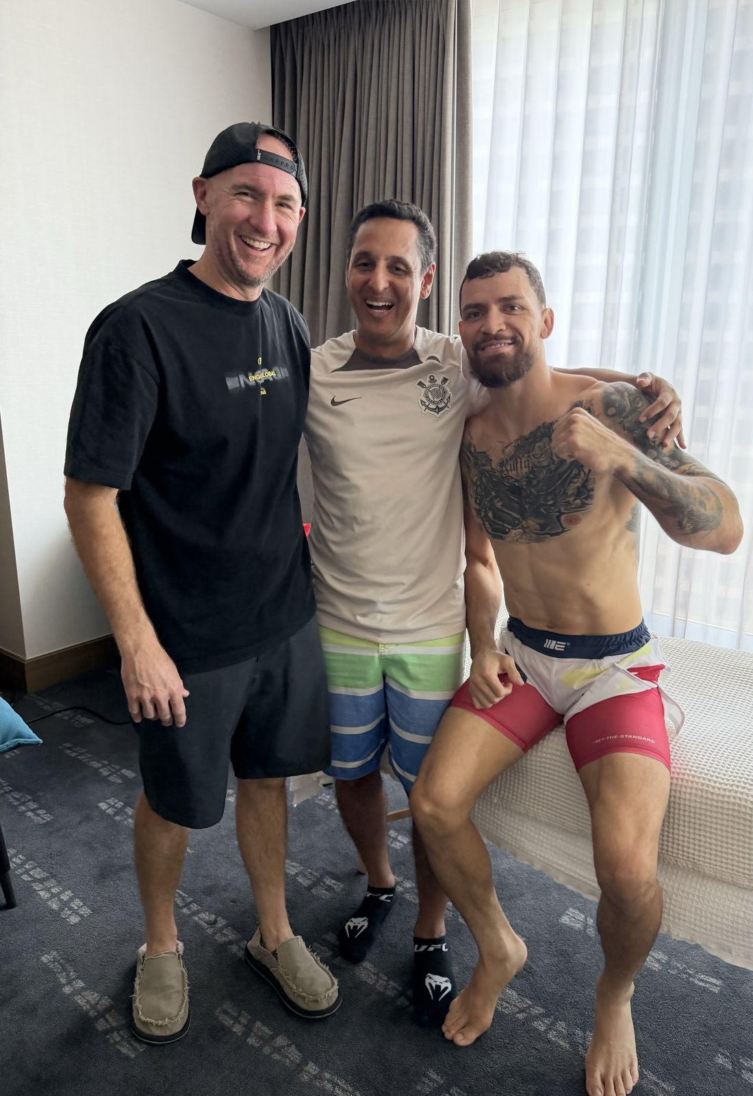 Three men in a hotel room on fight day