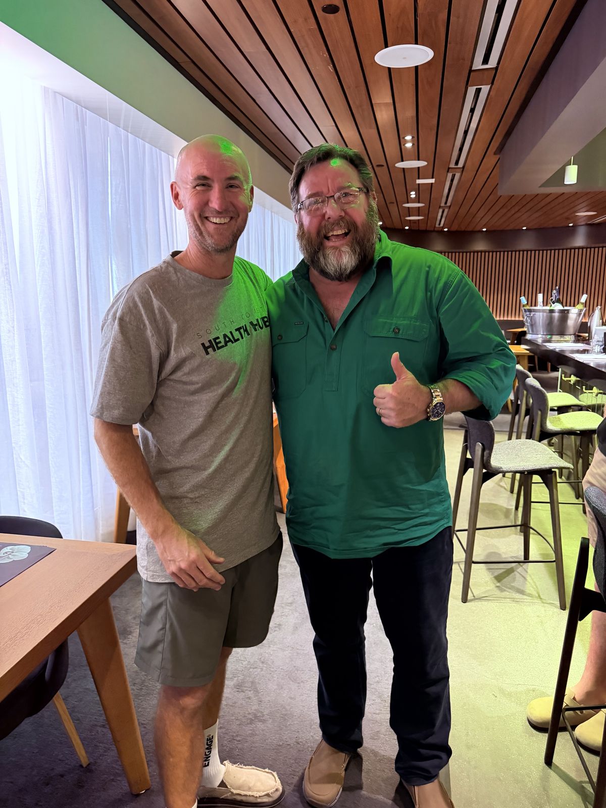 Mick Baines and Shane Jacobson standing together, Shane giving a thumbs up