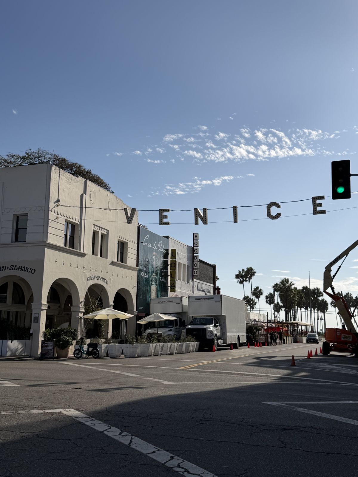 The VENICE sign strung across the street above Windward Avenue on a clear afternoon