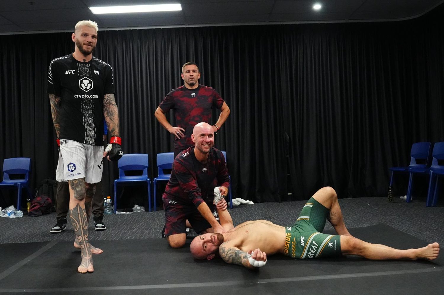 Fight-day physiotherapy backstage at UFC 325 in Sydney.