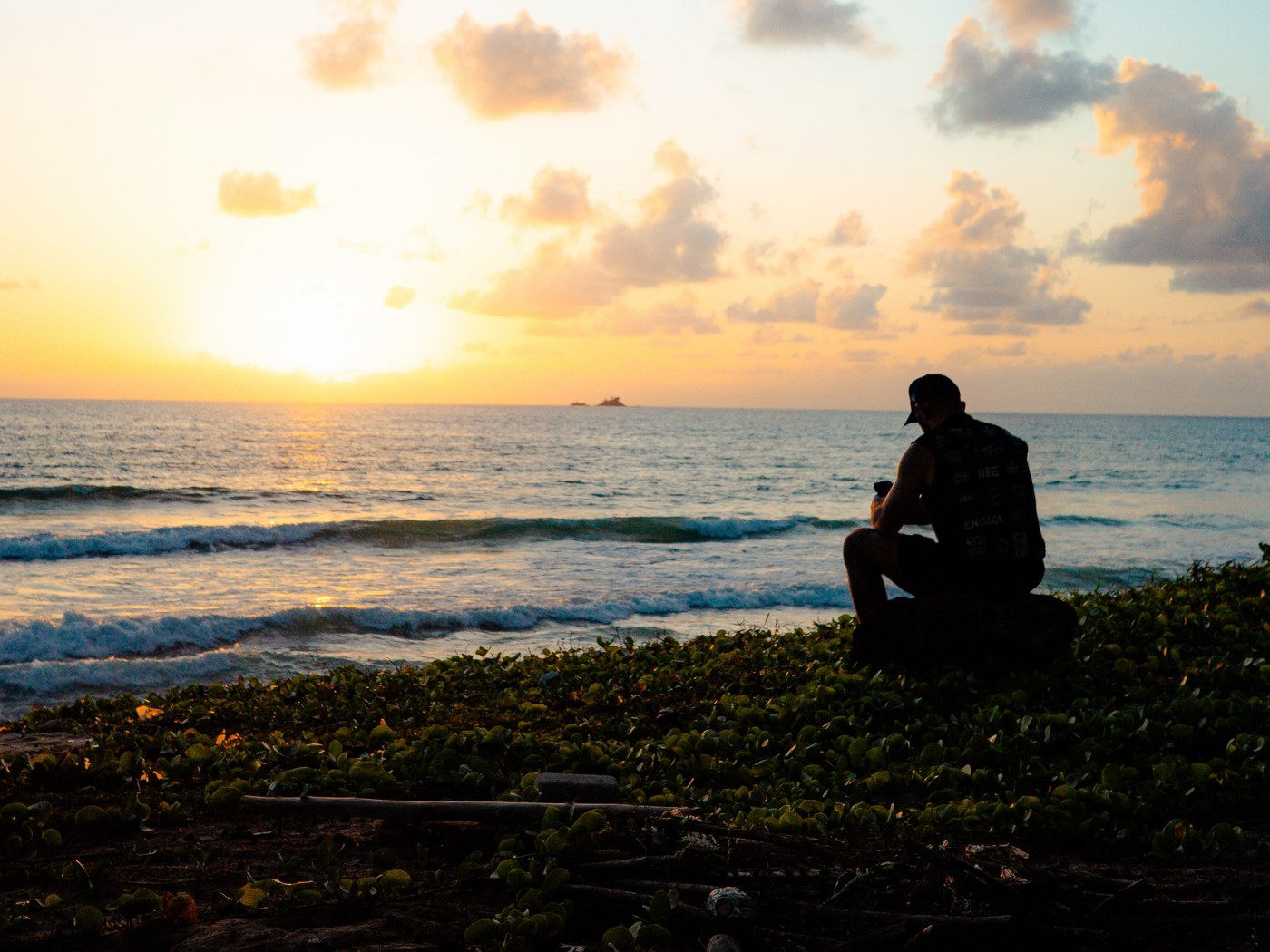 Sunset over the sea at Bang Tao, one figure sitting on the foreshore